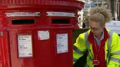 A woman at a post box