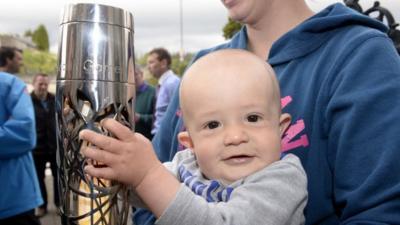 Reyna Cowill (right) and Leif Cowill get to see the Commonwealth Games Baton up close as it makes its way around Northern Ireland.