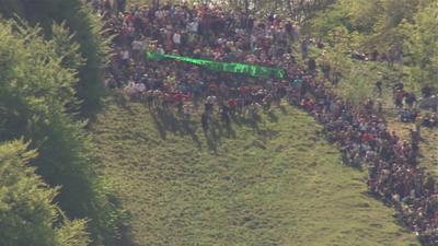 A cheese-rolling race begins in Gloucestershire