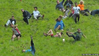 Competitors in the Cheese Rolling on Cooper's Hill race near Brockworth, Gloucestershire