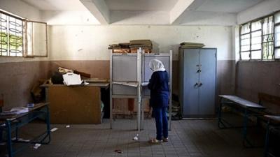 An Egyptian voter selects a candidate at a polling station in the Cairo