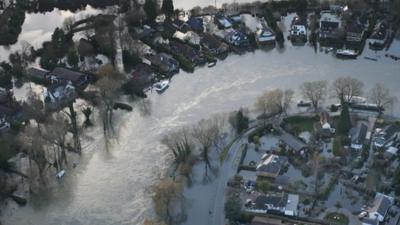 Flood water (flood waters) surrounds houses on February 16, 2014 near Walton on Thames, England.