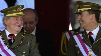 Spanish King Juan Carlos (L) and Spain"s Crown Prince Felipe smile during a military ceremony marking the bicentenial of the Royal and Military Order of Saint Hermenegild (Real y Militar Orden de San Hermenegildo) in El Escorial on June 3, 2014