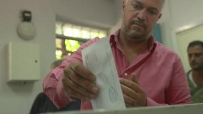 A man votes in Syria's presidential elections