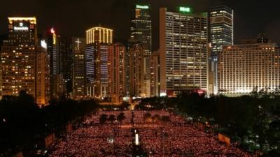 Tens of thousands of people holding candles in Victoria Park, Hong Kong