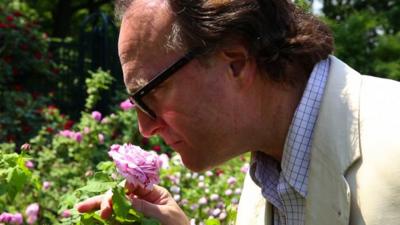 Andrea Di Robilant smelling a rose