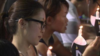 A woman at the vigil