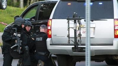 Police take cover in Moncton. 4 June 2014