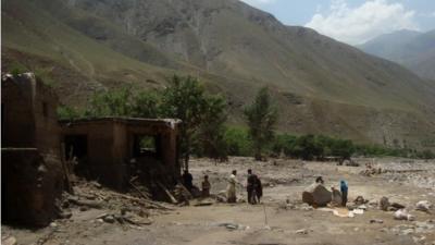 Afghan villagers search at the site after a flashflood landslide in the Guzargah-e-Nur district of Baghlan province on June 7, 2014