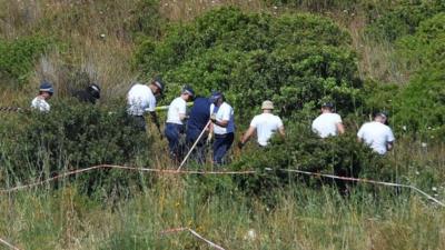 Police searching scrubland