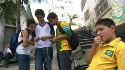 Brazilian football fans looking at football cards