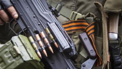 A pro-Russian separatist with an attached orange ribbon of St. George