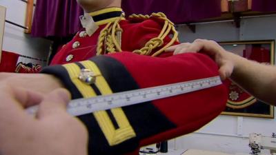 Someone measuring uniform