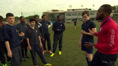 Pupils receiving football coaching