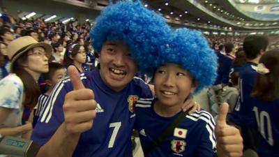 Man and boy in blue wigs and Japan strips