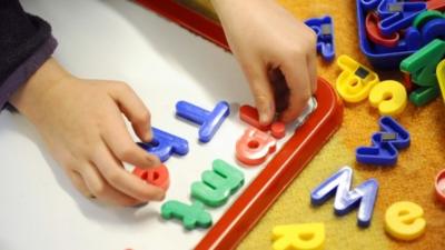 Primary school child with magnetic letters