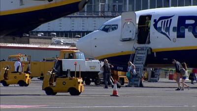 Passengers disembark a plane