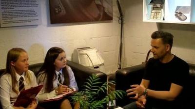 The man who made the Queen's Baton being interviewed by School Reporters