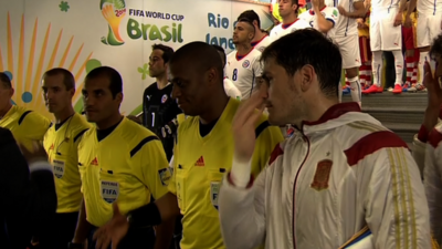 Spain's Iker Casillas watches an assistant referee be passed over for a handshake