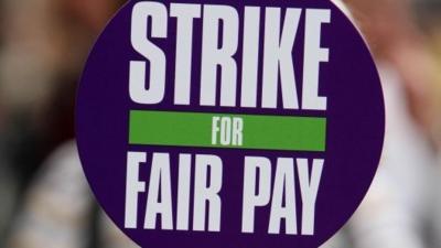 Unison sign saying "strike for fair pay"