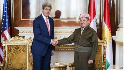 Kurdish President Massoud Barzani, right, shakes hands with US Secretary of State John Kerry