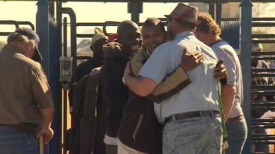 Miners greet each other as they return to work