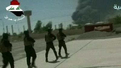 Off-air TV pictures of troops on ground at Baiji refinery, black smoke rising