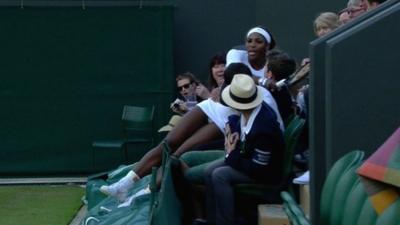 Serena Williams falls into a spectator's lap at Wimbledon during a doubles' match on day three