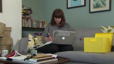 Woman working with laptop on sofa