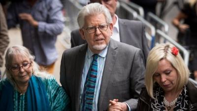 Rolf Harris flakned by his wife Alwen and daughter Bindi