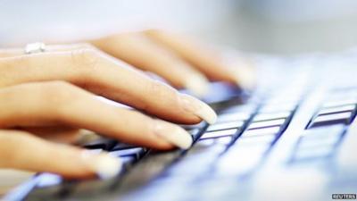 Woman typing on a computer