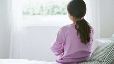 Girl sitting on bed