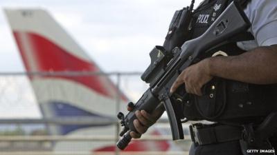 Armed police officers patrol at Heathrow Airport terminal