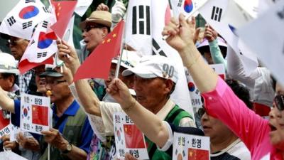 Conservative activists stage a rally welcoming Chinese President Xi Jinping's visit to South Korea, near the Chinese Embassy in Seoul, South Korea