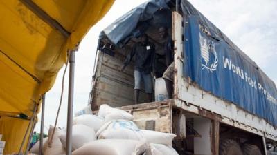 A truck from the World Food Programm (WFP) delivers bags of food