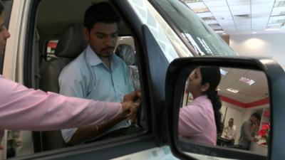 Customers in a car showroom