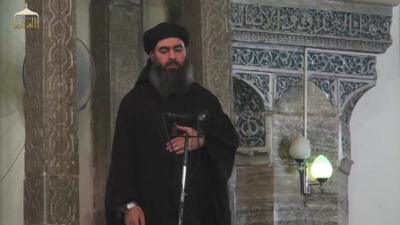 Still from Isis video of Abu Bakr al-Baghdadi in a mosque