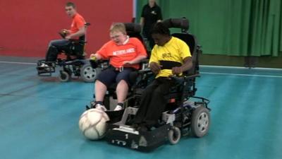 Children playing powerchair football