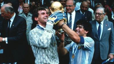 Nery Pompido and Diego Maradona hold aloft the World Cup