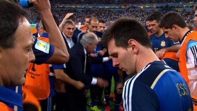 Lionel Messi walks away from the Argentina team talk before the start of extra time during the 2014 World Cup final against Germany