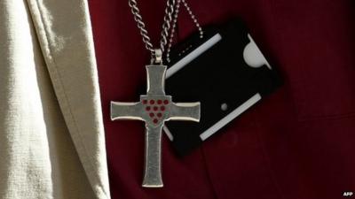 General Synod member wearing cross