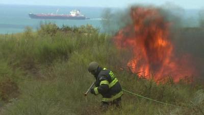 Firefighter tackles flames after rocket strike