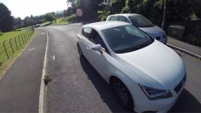 Car nearly hits cyclist