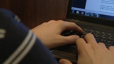 A person typing on a keyboard