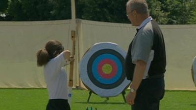 Child taking part in archery session