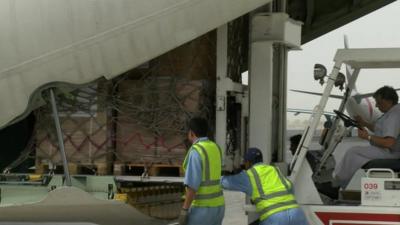 Aid packages loaded into plane