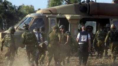 Israeli soldiers evacuate a wounded soldier