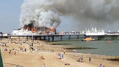 Fire and smoke engulf the pier