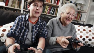 Boy and grandma playing video game