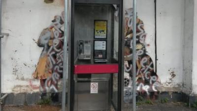 Defaced Banksy "Spy Booth" mural